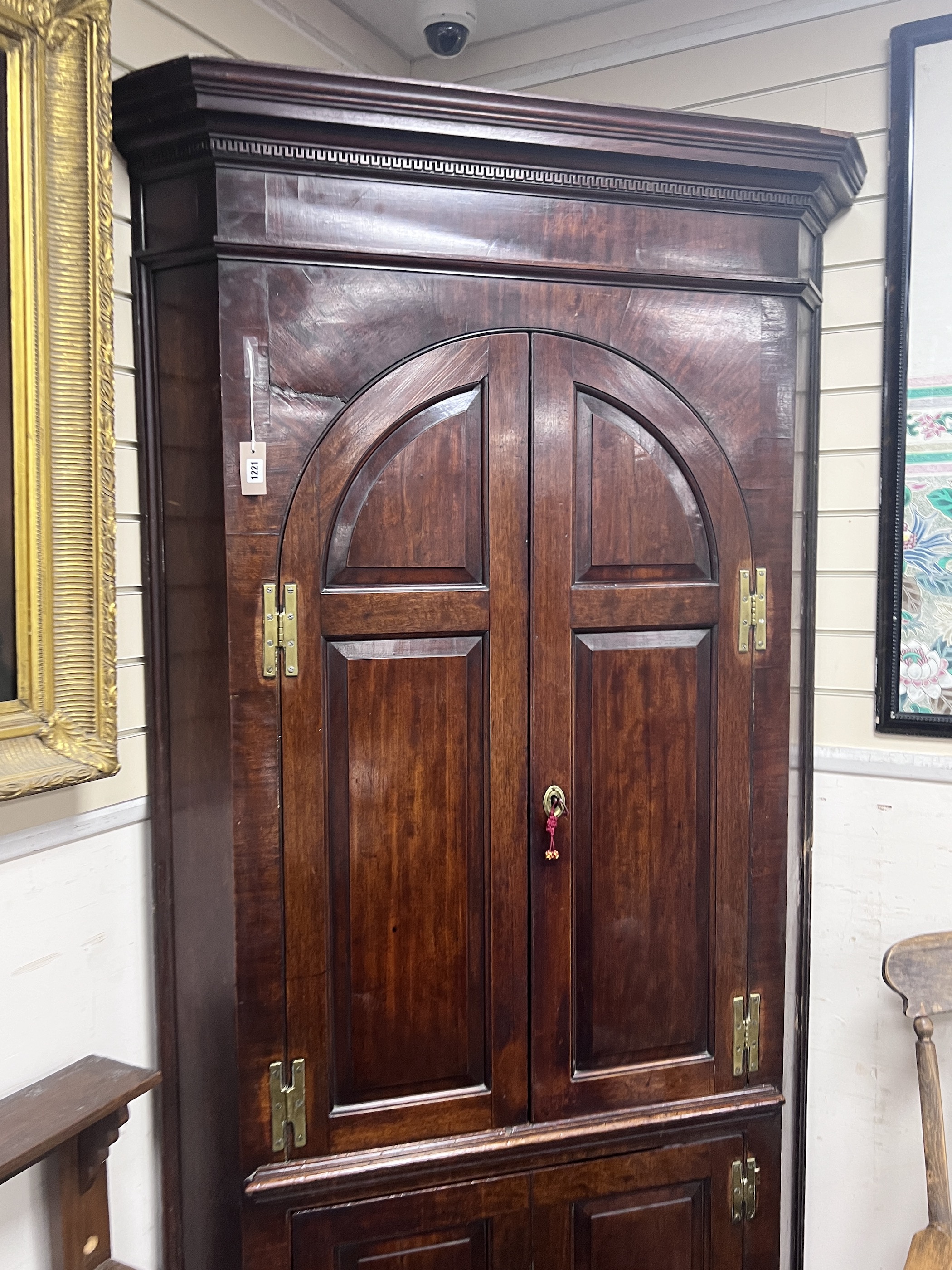 A George III mahogany standing corner cabinet, width 110cm, depth 56cm, height 228cm